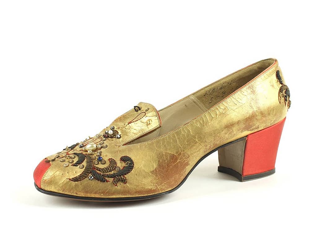 A gold shoe with a red heel from the 18th century